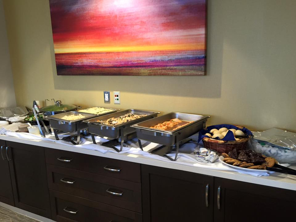 Corporate catering on top of a countertop inside of an office's conference room.